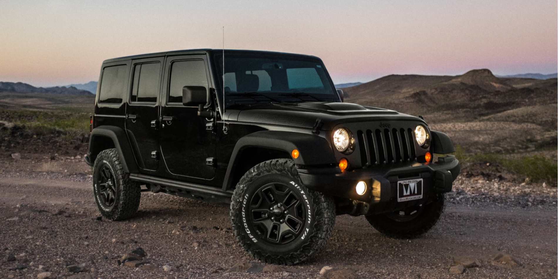 A black Jeep Wrangler parked on the road