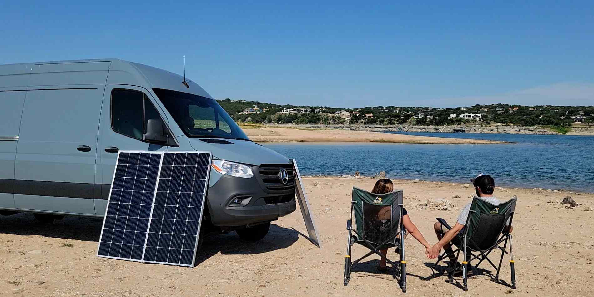 A couple camping near a river with BougeRV's solar panels