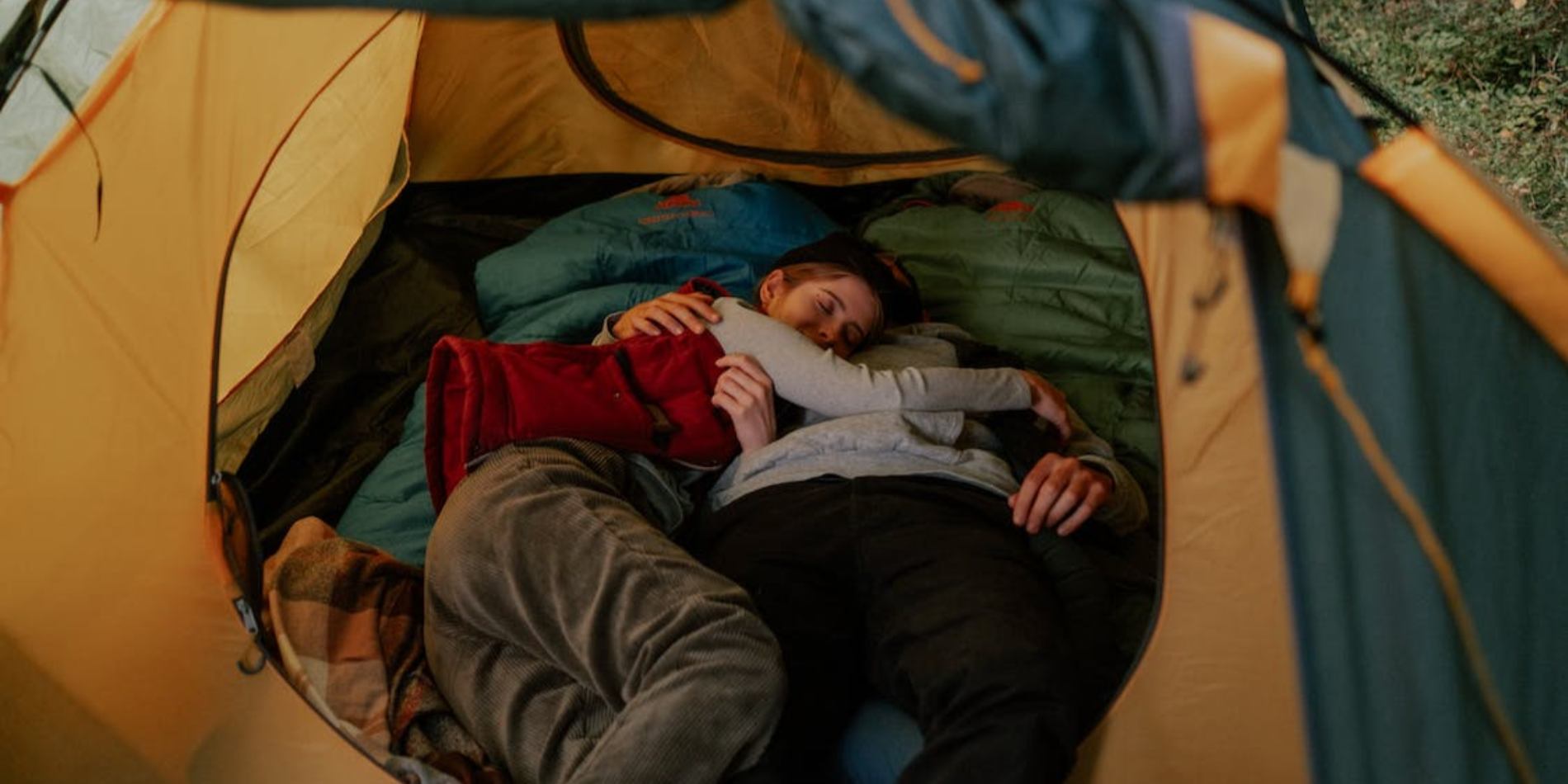 A couple sleeping in a tent