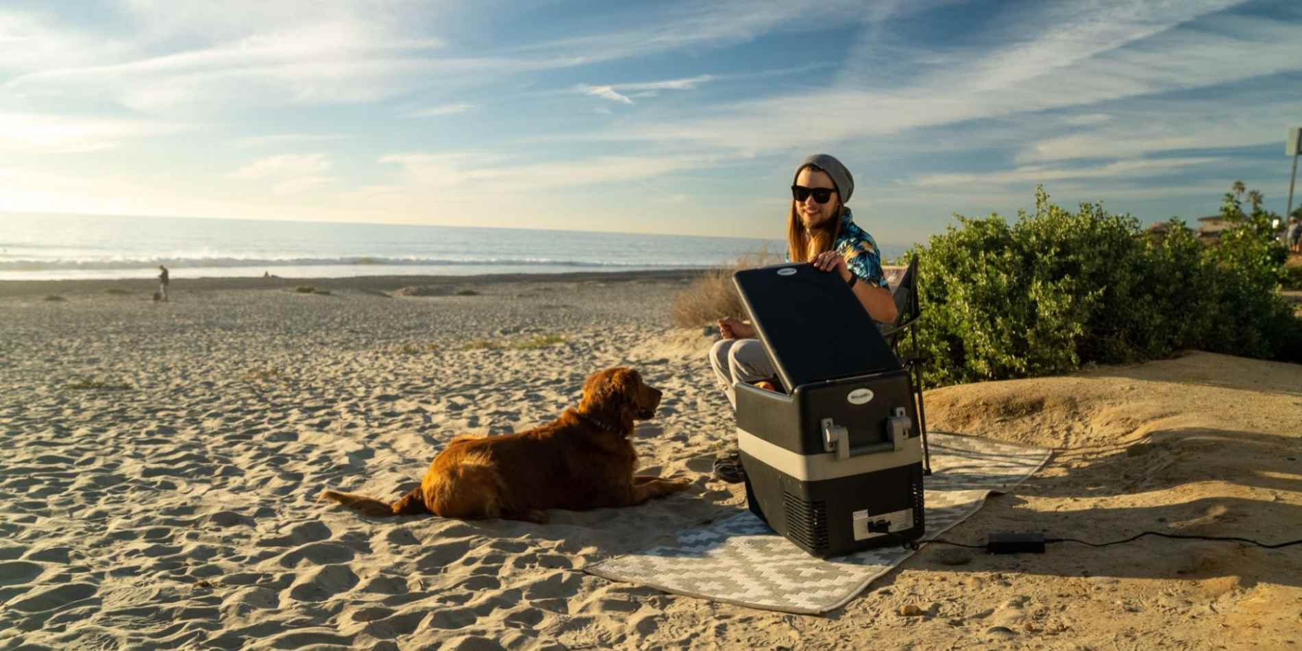 A man cooling food using BougeRV portable refrigerator for Labor Day weekend Camping