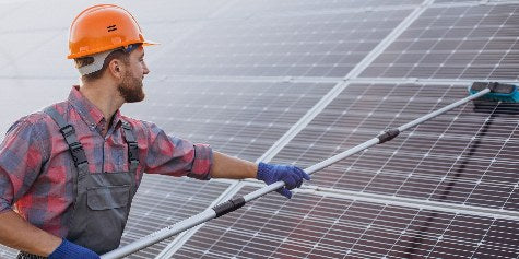 A man worker cleaning solar panels
