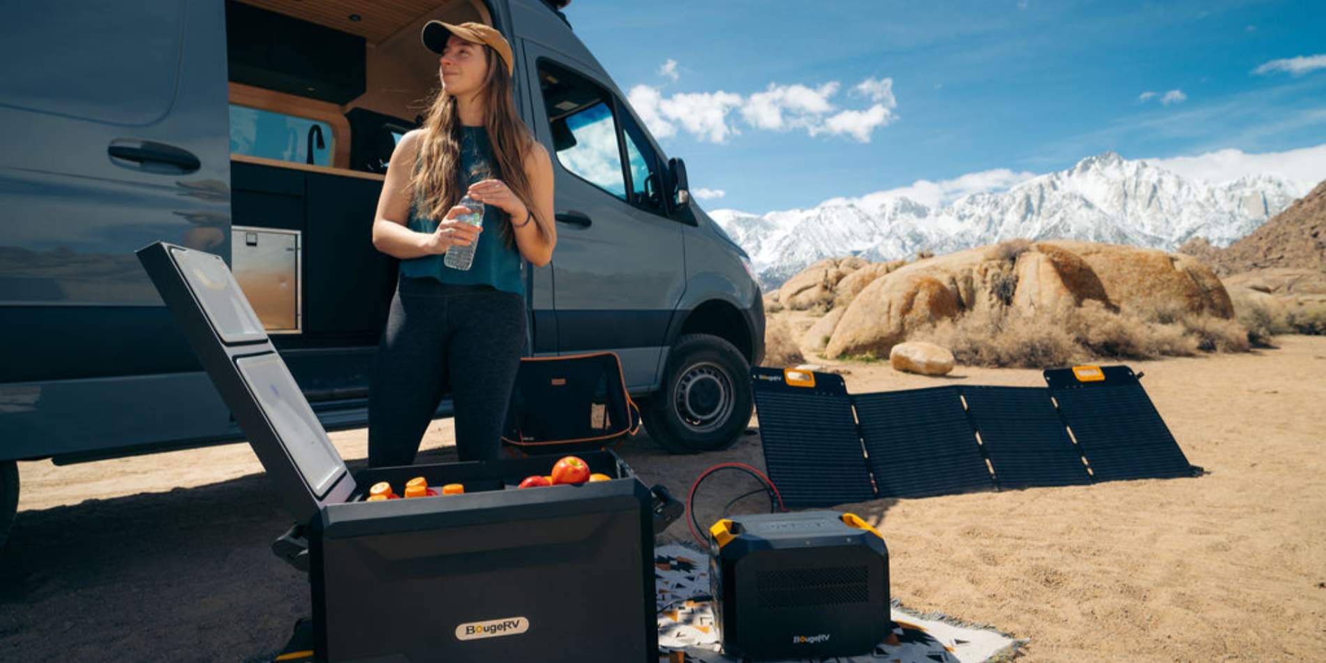 A woman camping with BougeRV’s 12V portable power station and solar panel